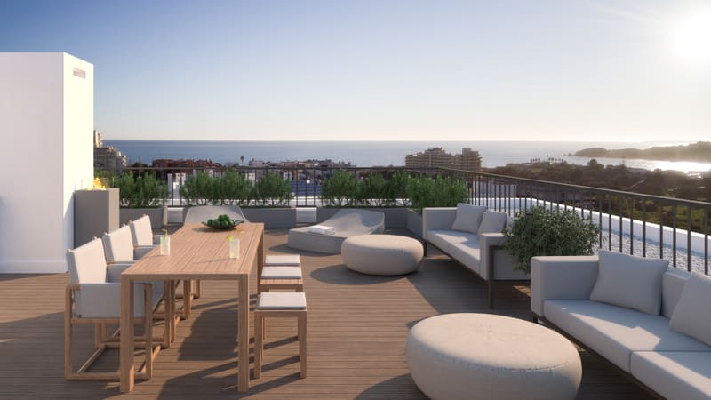 Rooftop terrace dining area at sunset, with sea views