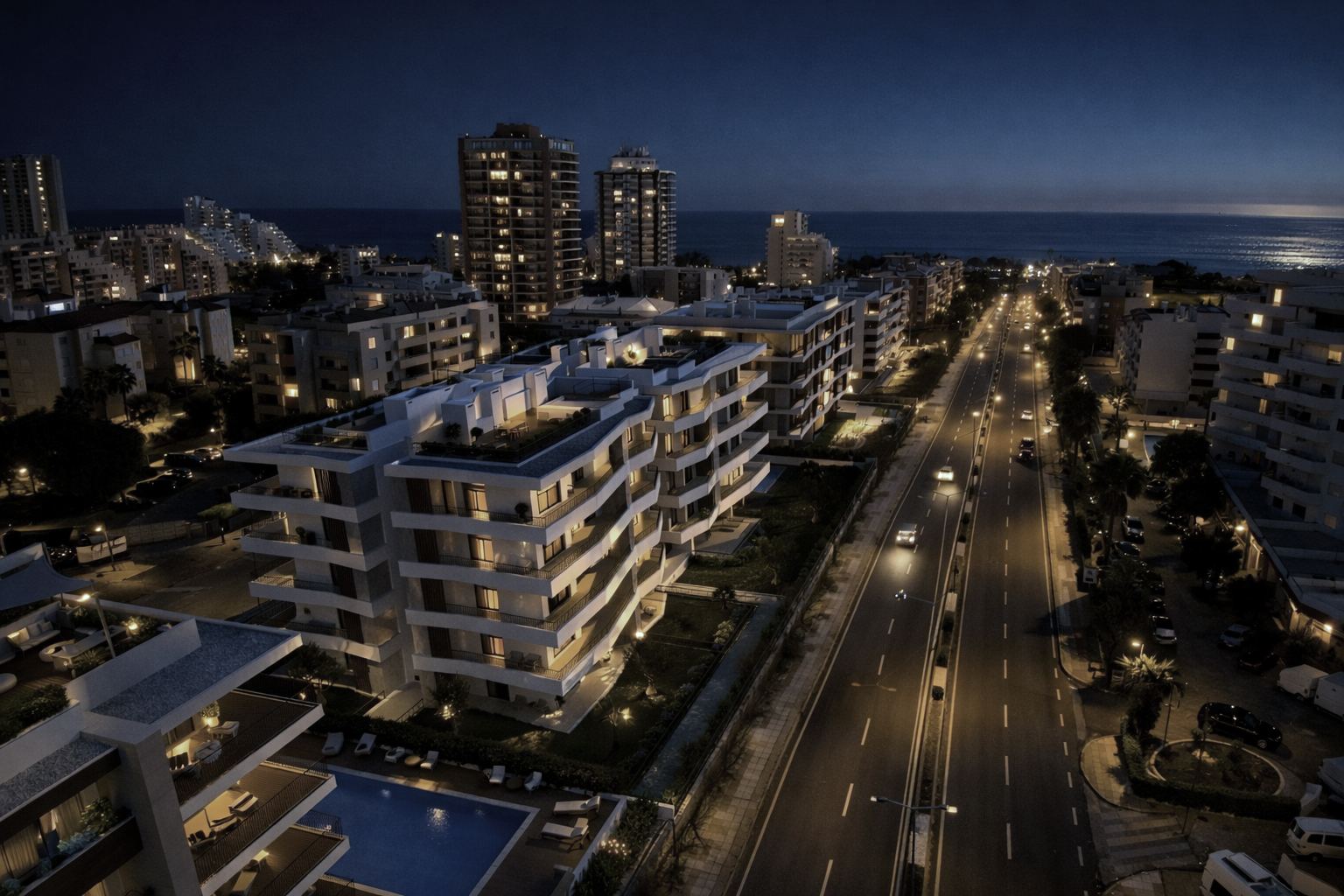 Vista aérea noturna do Litoral Blue e das luzes de Portimão até ao mar