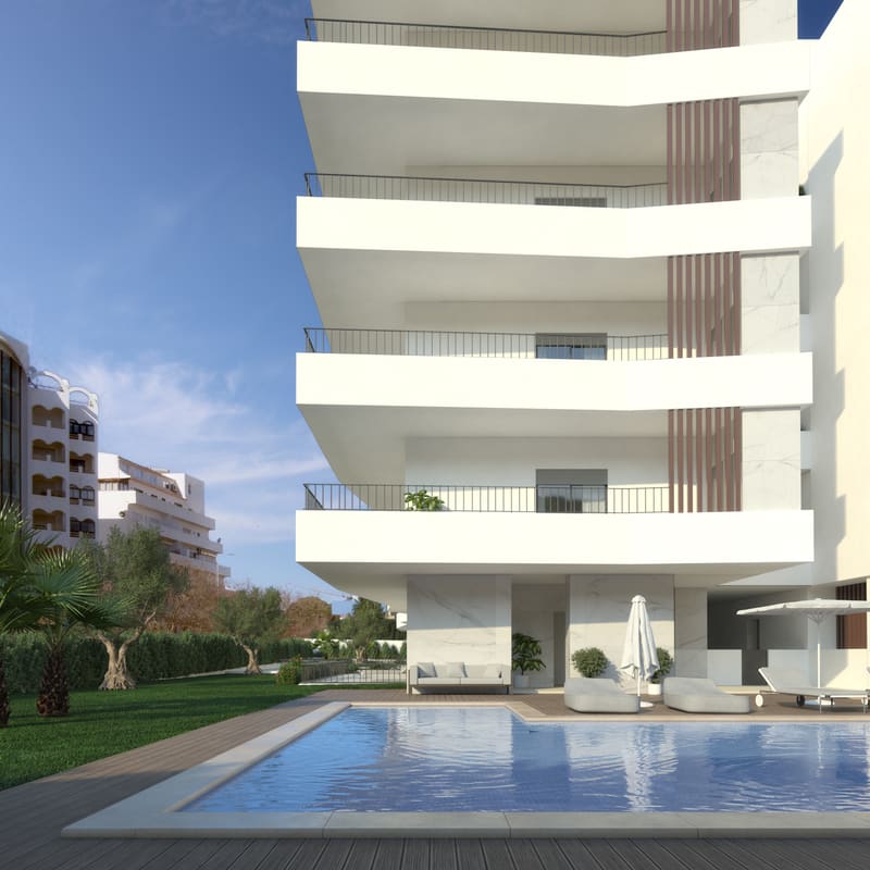 Deck and outdoor pool of the development, surrounded by garden